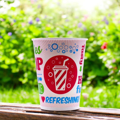 9oz Chill Cold Paper Cup PE with colourful text and a drink icon on a wooden surface with a green, blurred natural background