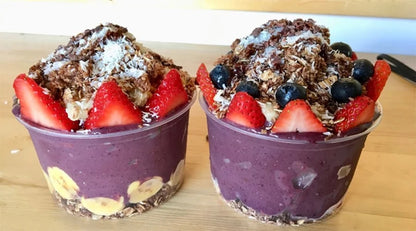 Two bowls 12oz Clear Round RPET Açaí Bowl Container with fruit and toppings on a wooden surface.