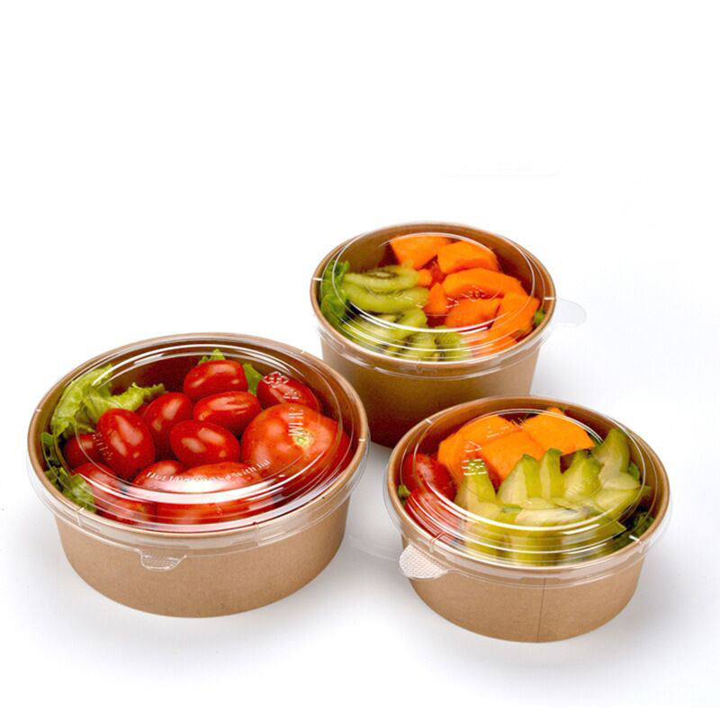 Three brown kraft salad bowls with lids filled with fruits and vegetables on a white background