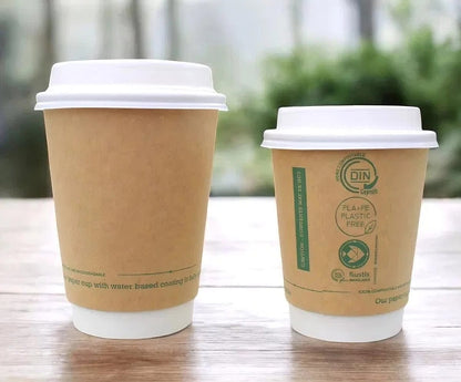 Two 12oz Kraft Aqueous Compostable Hot Cups and Lids on a wooden surface, one with visible branding.