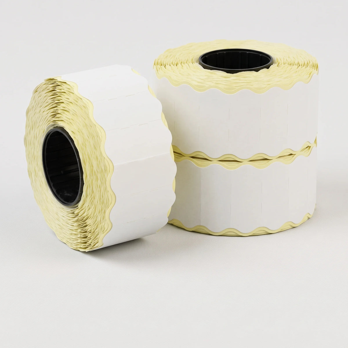 3 rolls of price gun labelss on a white backgrounfd