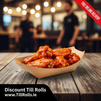 Bowl of fried chicken in an 3lb Kraft 2.5lb Greenspirit kraft food tray – 133x82x48mm corrugated paperboard, natural finish on a wooden table with blurred restaurant background and 'Free Ireland Delivery' banner.