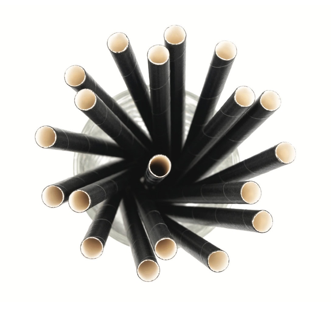 Black straws with beige tips arranged in a circular pattern on a white background