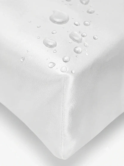 Close-up of a white cover  with water droplets on the corner to demonstrate its waterproof and breathable properties.lip