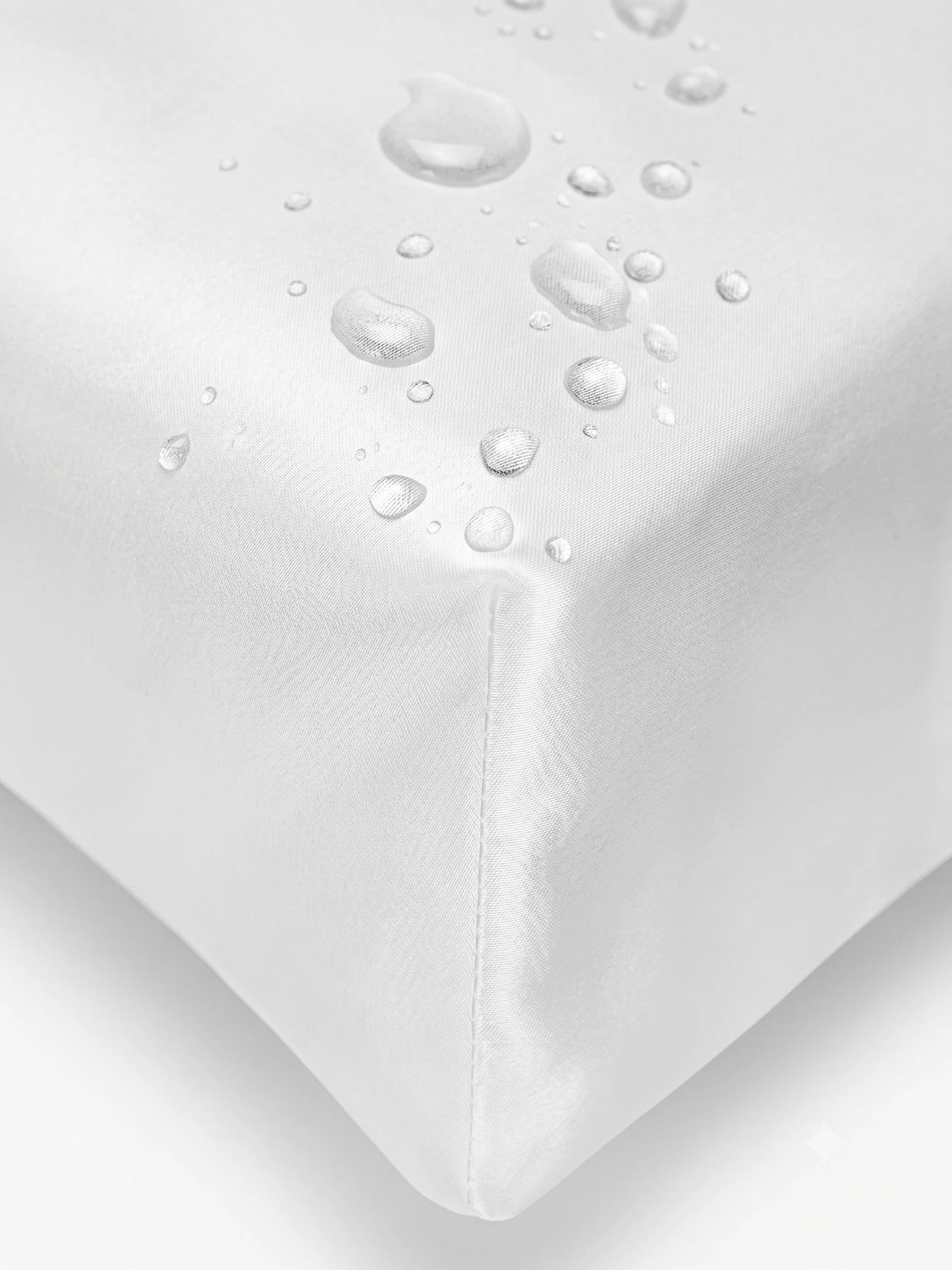 Close-up of a white cover  with water droplets on the corner to demonstrate its waterproof and breathable properties.lip