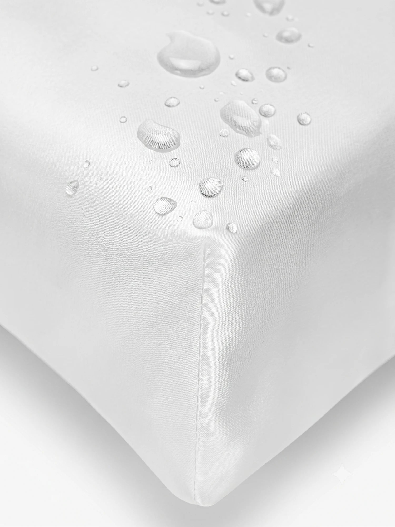 Close-up of a white cover  with water droplets on the corner to demonstrate its waterproof and breathable properties.lip