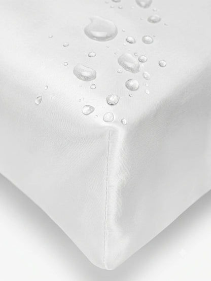 Close-up of a white cover  with water droplets on the corner to demonstrate its waterproof and breathable properties.lip