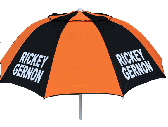 Orange and black racecourse bookmakers umbrella with 'Rickey Gernon branding on a dark background