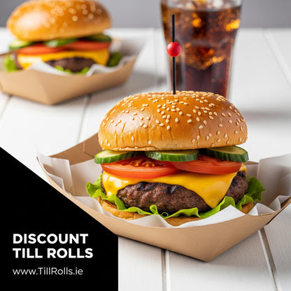 Hamburger with cheese, lettuce, tomato, and cucumber in a sesame seed bun, served in a 3lb Kraft Greenspirit Paper Food Trayr with a drink on a white wooden table.