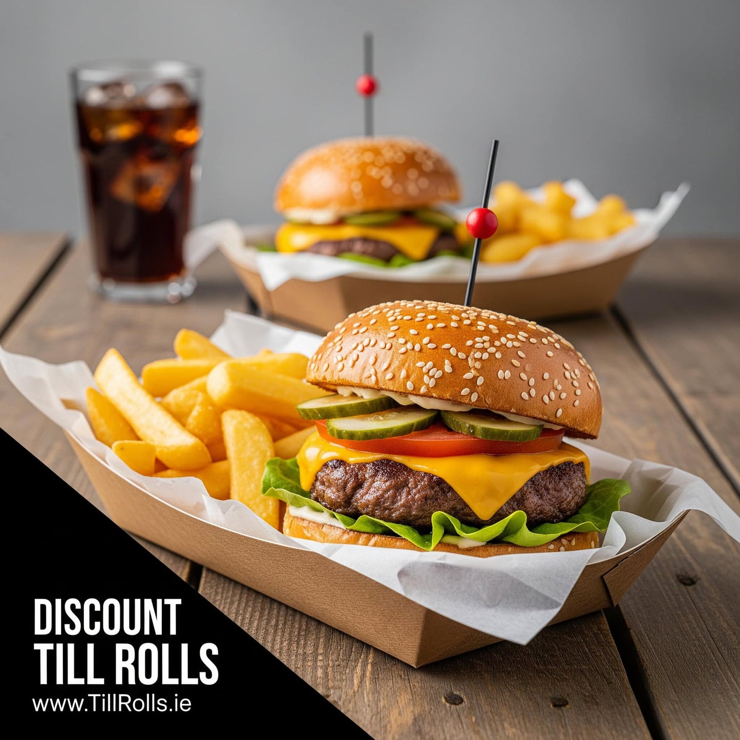 Two burgers with fries in a 3lb Kraft Greenspirit Paper Food Tray and a drink on a wooden table, with 'Discount Till Rolls' branding.