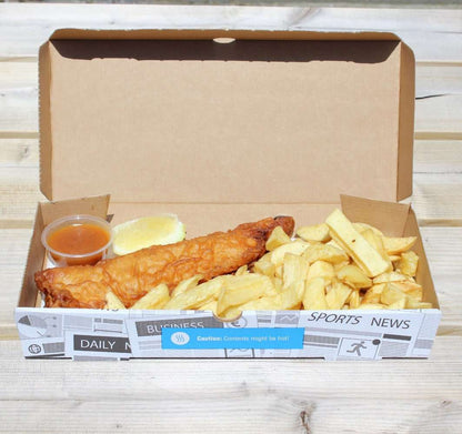 Box of fish and chips with a side of sauce on a wooden surface