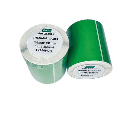 Two rolls of Green For Zebra Thermal Label tape, showing the green adhesive side and the white paper carrier side, on a plain white background.