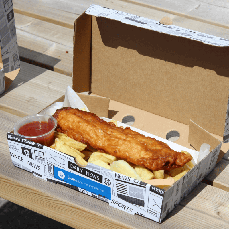 Large Corrugated Fish & Chip Box with fish and chips with a side of ketchup on a wooden surface